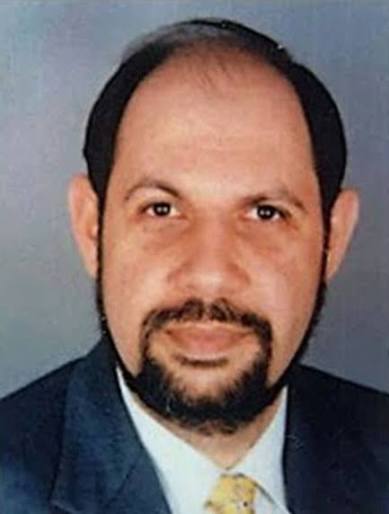 Formal head-and-shoulders portrait of Hormusji N. Cama in a dark suit, white shirt and patterned tie, looking directly at the camera.